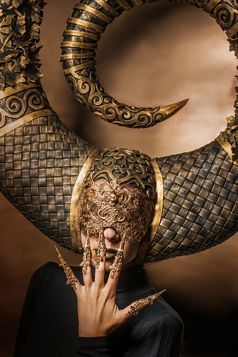 Beautiful blonde fantasy woman wearing a unique symbolic head piece in a studio shot