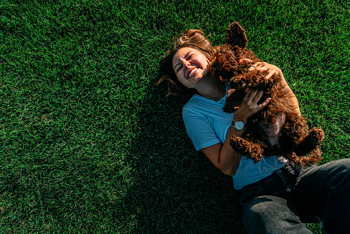 Portrait of a Cheerful, Attractive, Happy Young Woman Holding Her Pet \