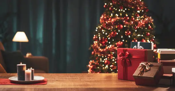 Home interior with Christmas tree and gifts in the foreground