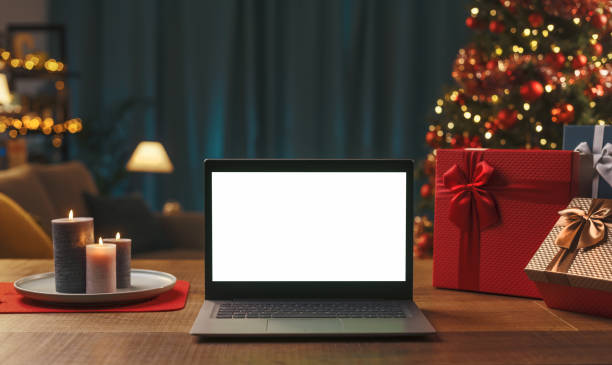 istock Laptop with blank screen, gifts and Christmas tree 1350632413