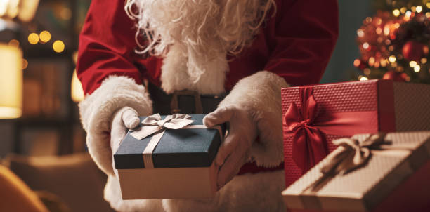 Santa Claus delivering Christmas gifts stock photo