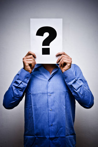 istock Man Holding Question Mark Sheet Paper in Front of Face 135063303