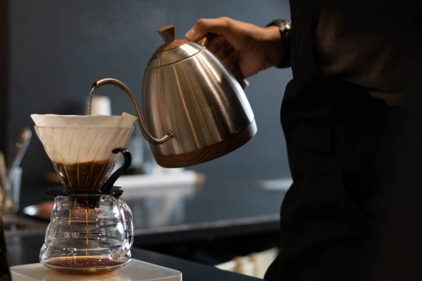 istock Barista preparing coffee using pour over coffee maker and drip kettle. Alternative ways of brewing coffee. Coffee shop concept. 1350633681