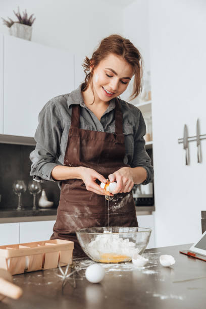 istock Young lady cooking the dough. 1350633854