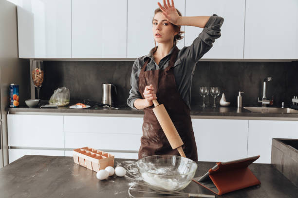 istock Woman standing in kitchen and cooking the dough 1350633953