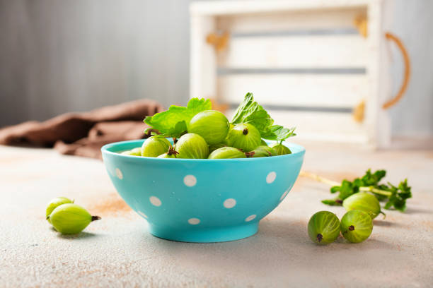 istock Fresh gooseberries in blue bowl. Top view. 1350634285