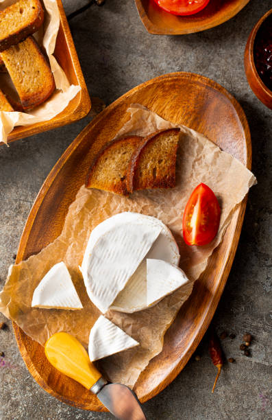 istock Camembert cheese. Round brie or camambert cheese. Selective focus 1350634312