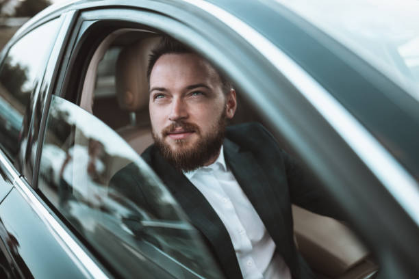 istock Handsome Businessman Enjoying View From Car Window 1350634559