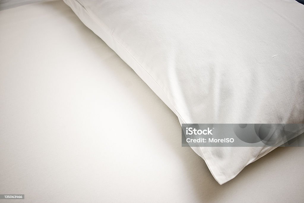 White Pillow Empty Bed White pillow and white bedsheet. Pillow Case Stock Photo