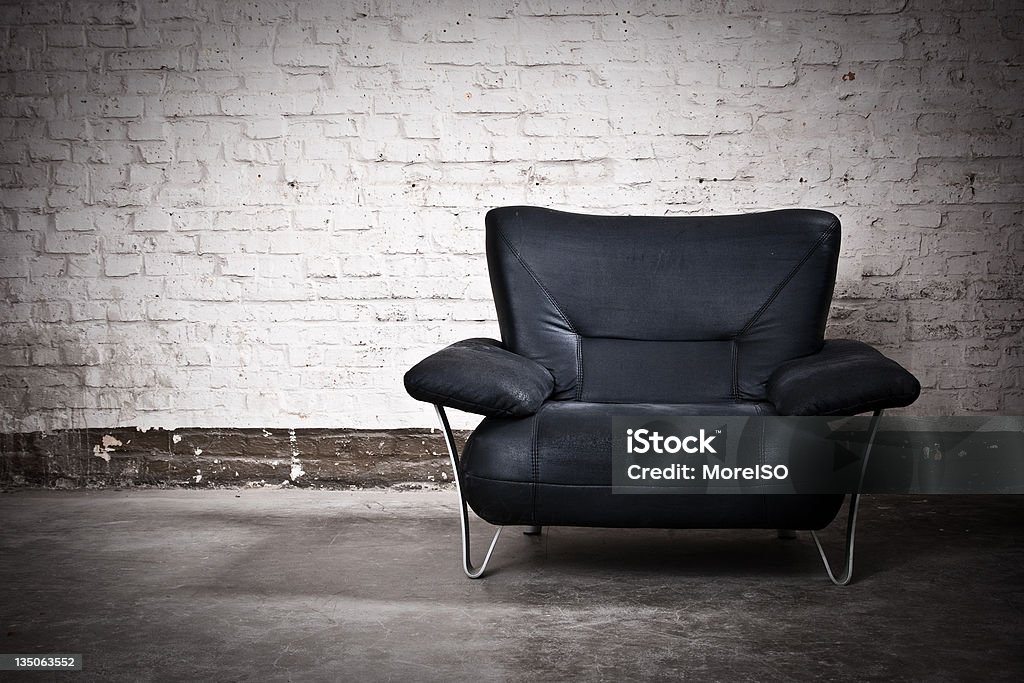 Black Armchair Nobody White Brick Wall Background Black armchair with bricks background. Black Color Stock Photo