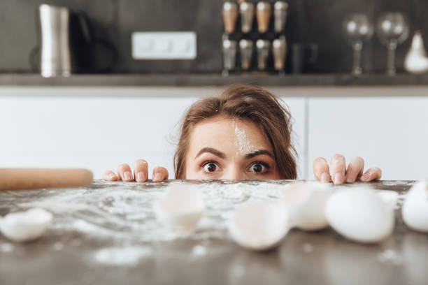 istock Woman sitting in kitchen while cooking the dough 1350635736