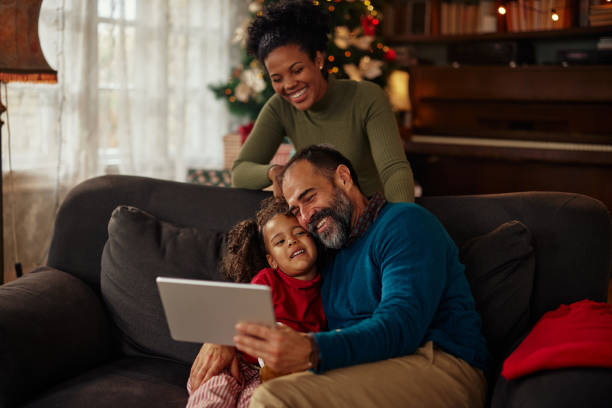 istock Cute little family bonding and using technology 1350635803