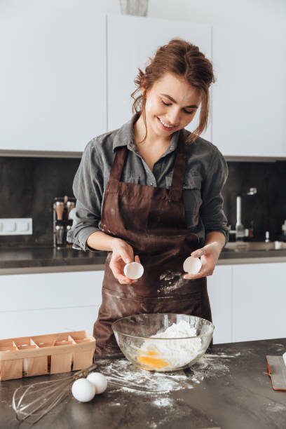 istock Young woman cooking the dough. 1350635837