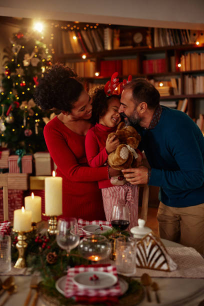 glückliche dreiköpfige familie am weihnachtstisch - 3 4 months stock-fotos und bilder