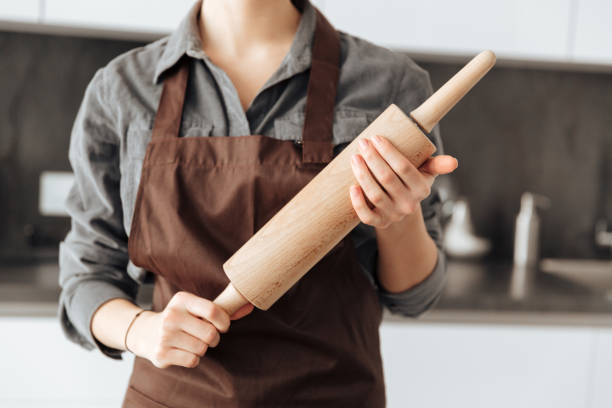 istock Cropped image of young woman standing in kitchen 1350636048