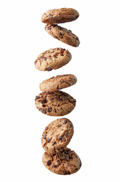 biscotti con gocce di cioccolato che cadono in pila - oat oatmeal isolated stack foto e immagini stock