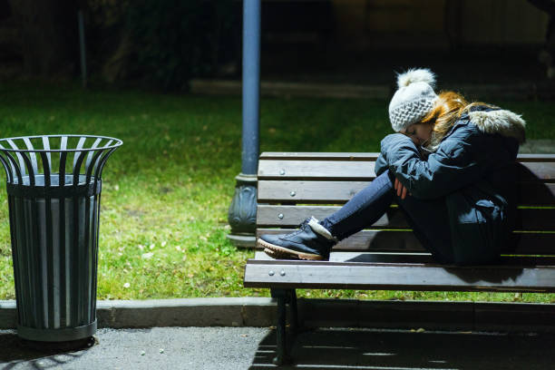 Woman feeling depressed while sitting on a bench