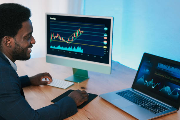istock African trader man working inside hedge fund office doing stock market analysis 1350645484