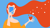 istock Woman using mobile phone with heart shapes 1350645847