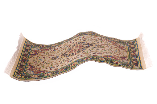 Magic carpet flying in the air, isolated in a white bacground
