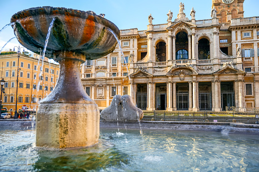 a fountain decorated with plaster and a power supply cable on the bottom, outdoor shot