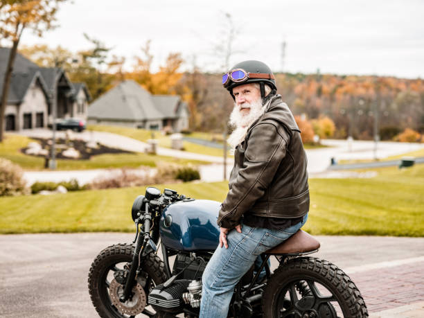 istock Senior man getting ready to ride his motorcycle 1350649296