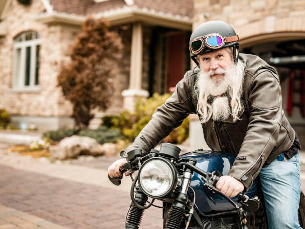 istock Senior man getting ready to ride his motorcycle 1350649319