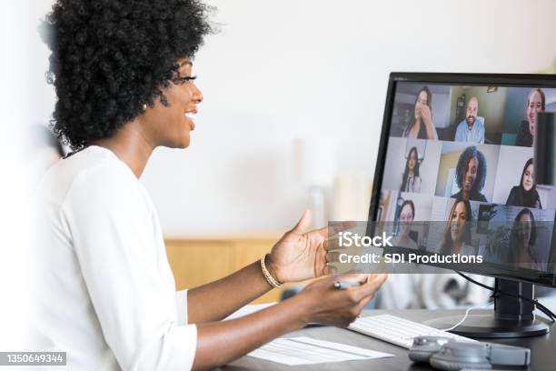 Female Financial Advisor Gestures During Meeting With Company Employees Stock Photo - Download Image Now