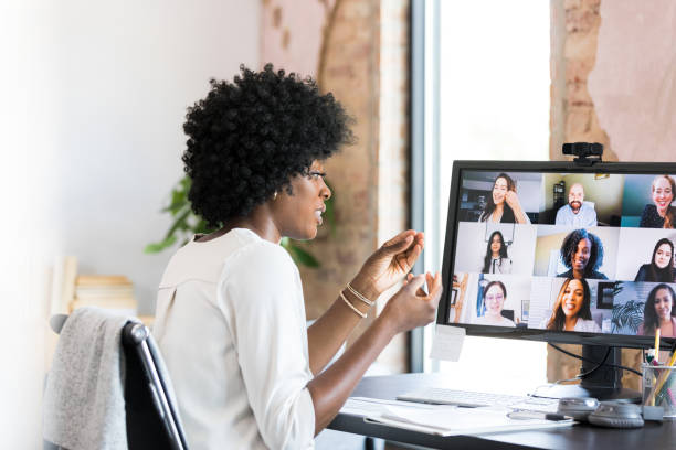 istock Businesswoman gestures during virtual meeting with co-workers 1350649354