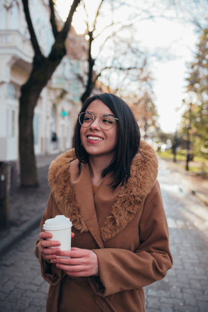 istock Young hispanic woman drinking coffee takeaway 1350649486