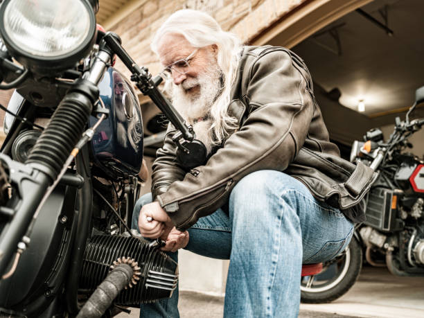 istock Senior man working on his racing motorcycle 1350649500