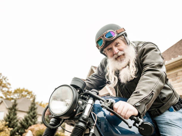 istock Senior man getting ready to ride his motorcycle 1350649665