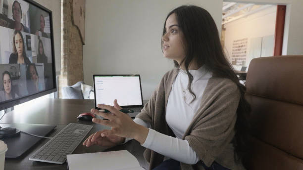 istock Female creative professional leads virtual meeting with diverse co-workers 1350649673