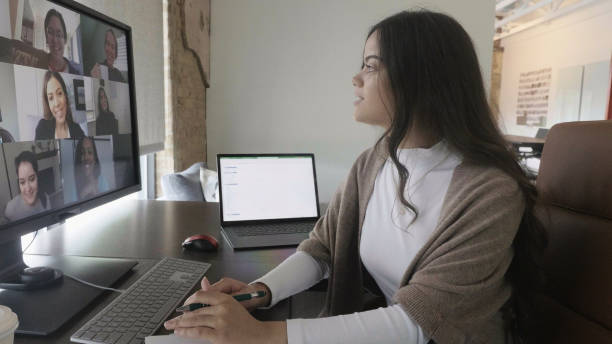istock Young adult female student takes notes during online class 1350649679