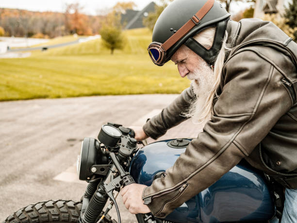 istock Senior man getting ready to ride his motorcycle 1350649701