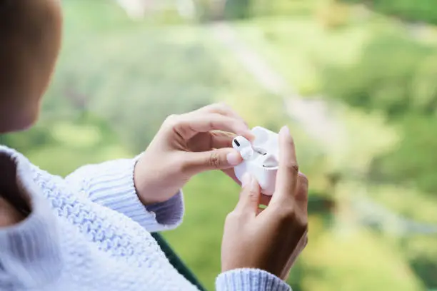 earbuds headphone in female hand, new headphone technology