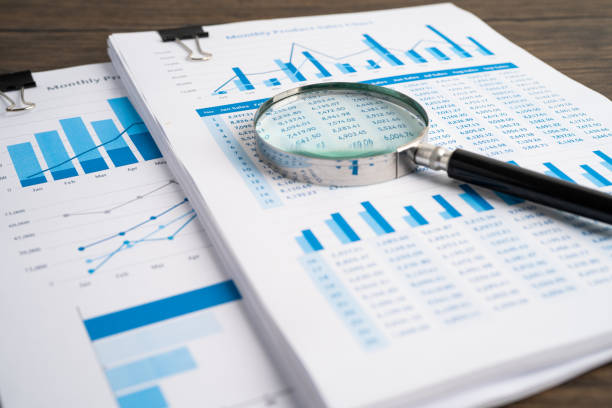 istock Magnifying glass on charts graphs paper. Financial development, Banking Account, Statistics, Investment Analytic research data economy, Stock exchange trading, Business office company meeting concept. 1350650942