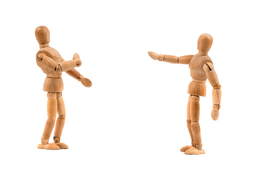 Wooden mannequin in dispute with another