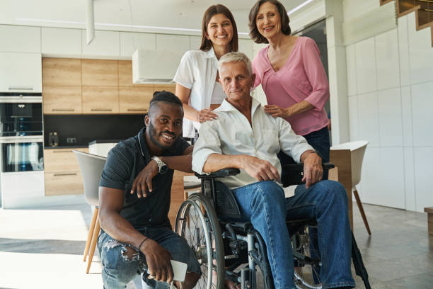 istock People supporting male with physical disability at home 1350652808