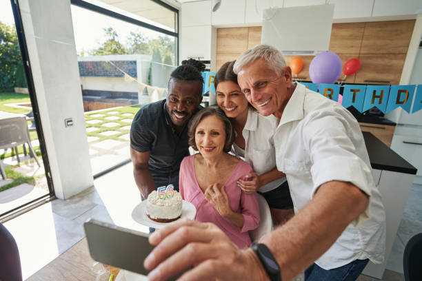 istock People looking at smartphone with charming smile 1350653189