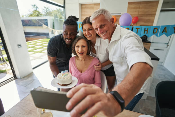 istock Family looking at smartphone with charming smile 1350653256