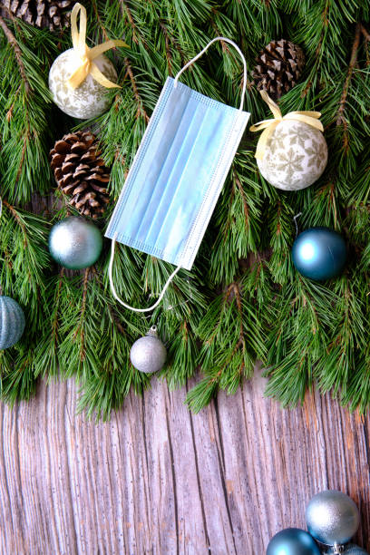 istock Christmas Tree Branches with medical mask, Background 1350653417
