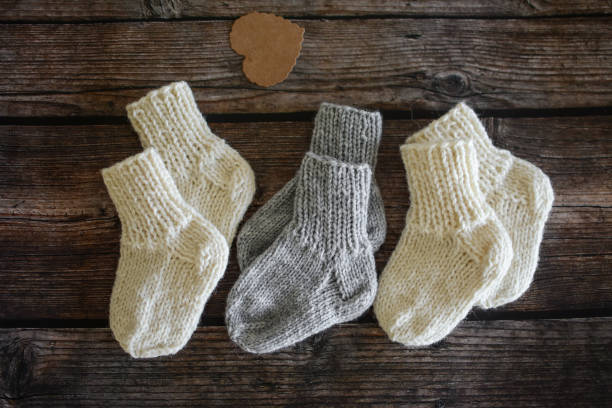 istock Chunky and warm handmade woolen socks on dark wooden background 1350653655