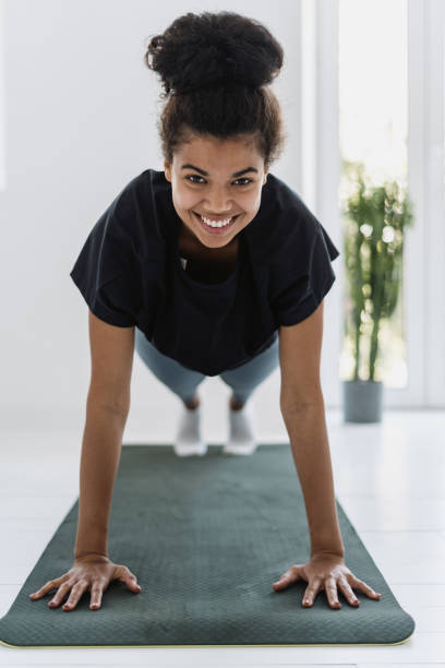 istock Afro american female doing sport training at home 1350655049