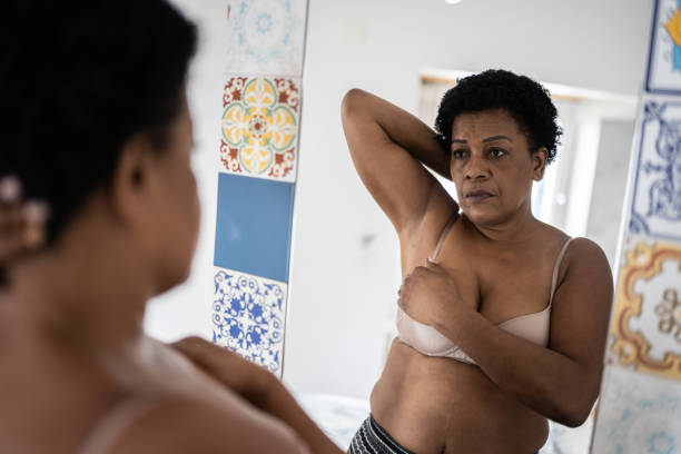 istock Mature woman doing self breast exam at home 1350655542