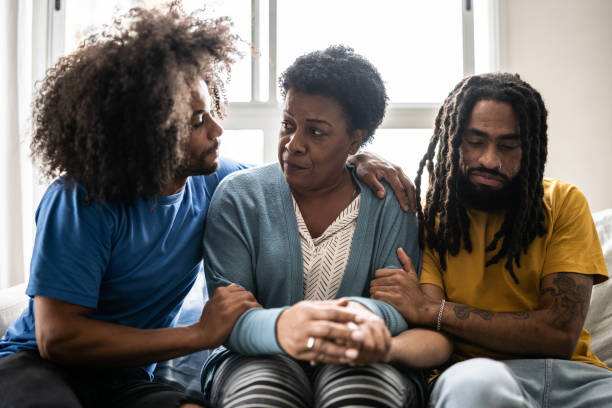 istock Sons consoling mother at home 1350656181