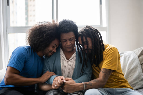 istock Sons consoling mother at home 1350656224