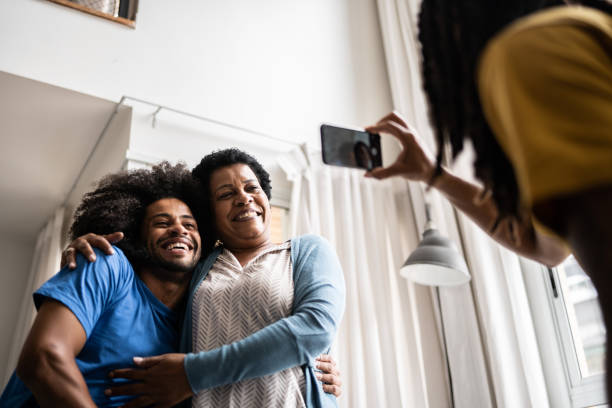 istock Man filming mother with her son at home 1350656889