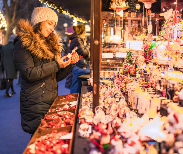 istock Choosing a Christmas gift at winter market stall 1350657795