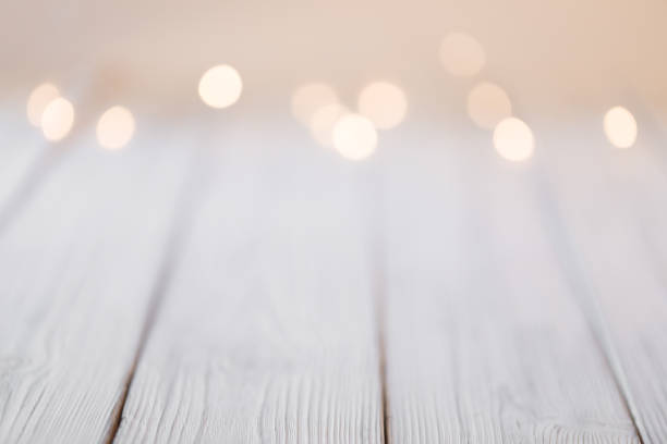 istock white abstract bokeh background behind wooden desk 1350657815